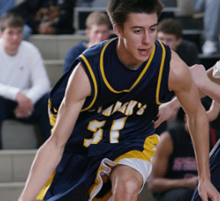 A photo of a student athlete playing basketball