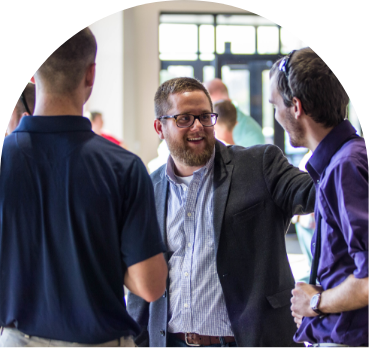 Church leader greeting congregants at a church