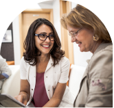 A female doctor talking to a female employee about her health.