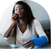 A woman on the phone with a cast on her arm.