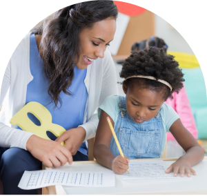 Female teacher working on crafts with a little girl student